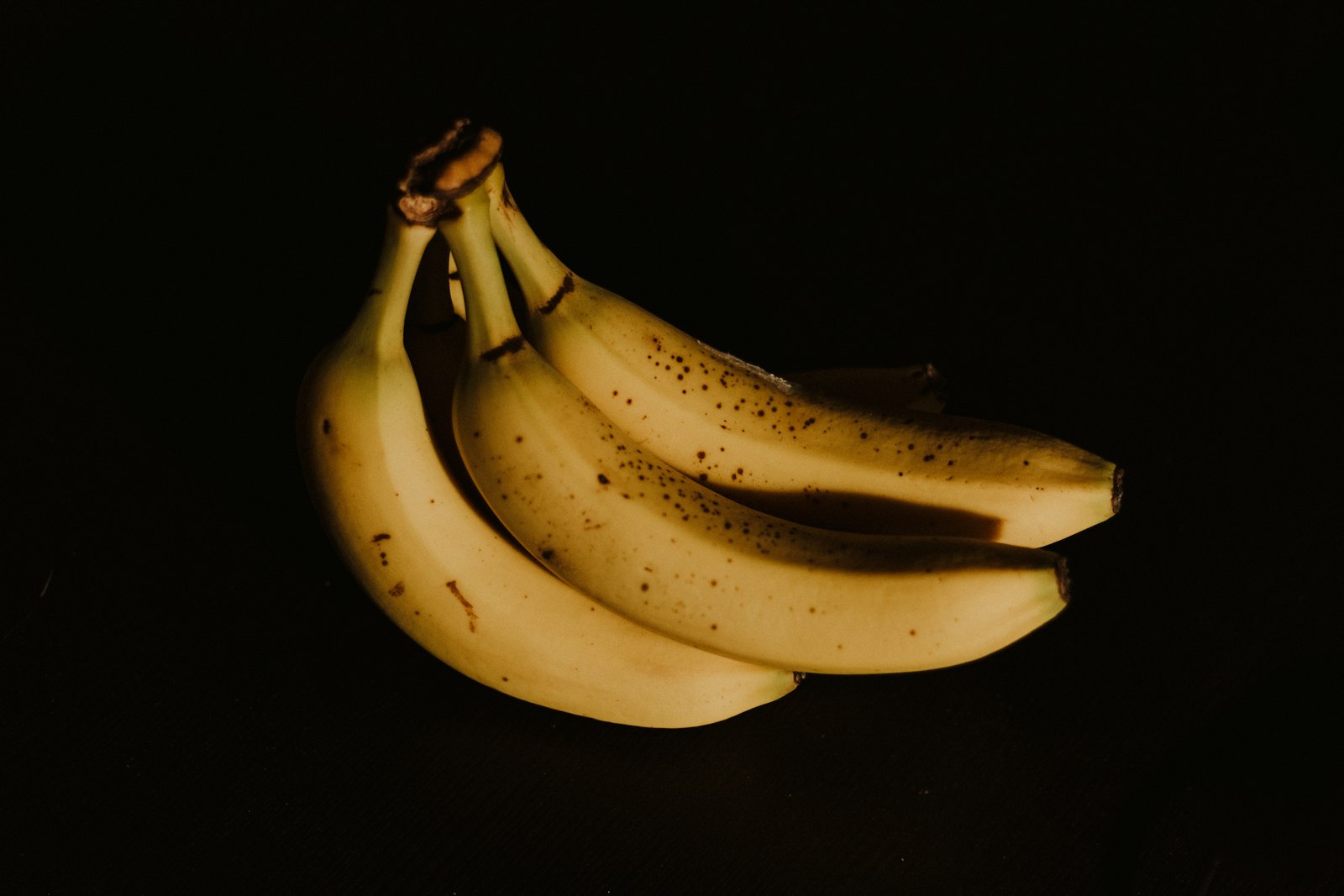 A moody bunch of bananas in low light